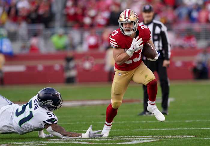 Jan 14, 2023; Santa Clara, California, USA; San Francisco 49ers running back Christian McCaffrey (23) gets past Seattle Seahawks linebacker Bruce Irvin (51) in the second quarter during a wild card game at Levi's Stadium. Mandatory Credit: Cary Edmondson-USA TODAY Sports